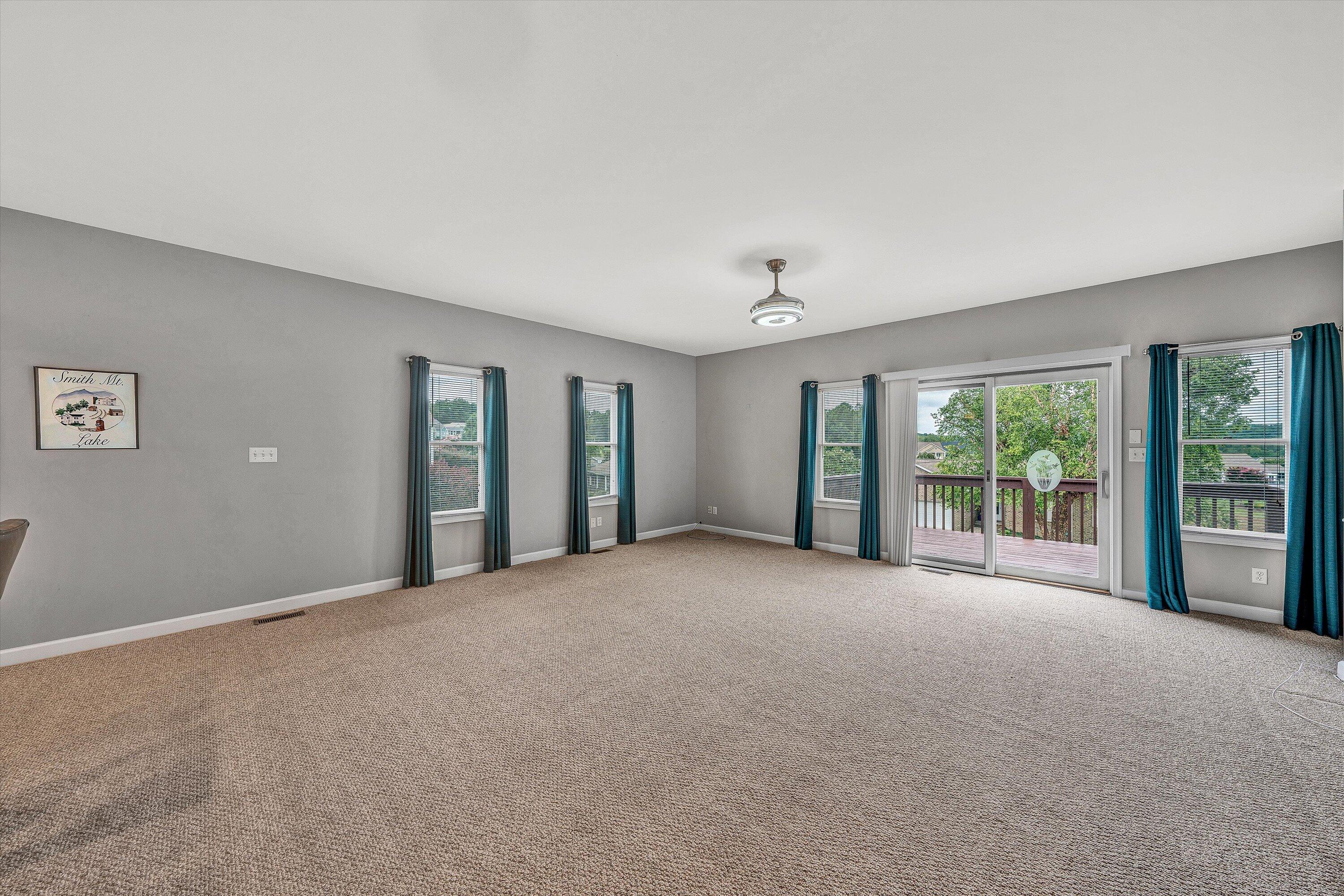 2326 Lake Retreat Road Huddleston, VA 24104 - Photo 32 of 42 a view of an empty room with large windows