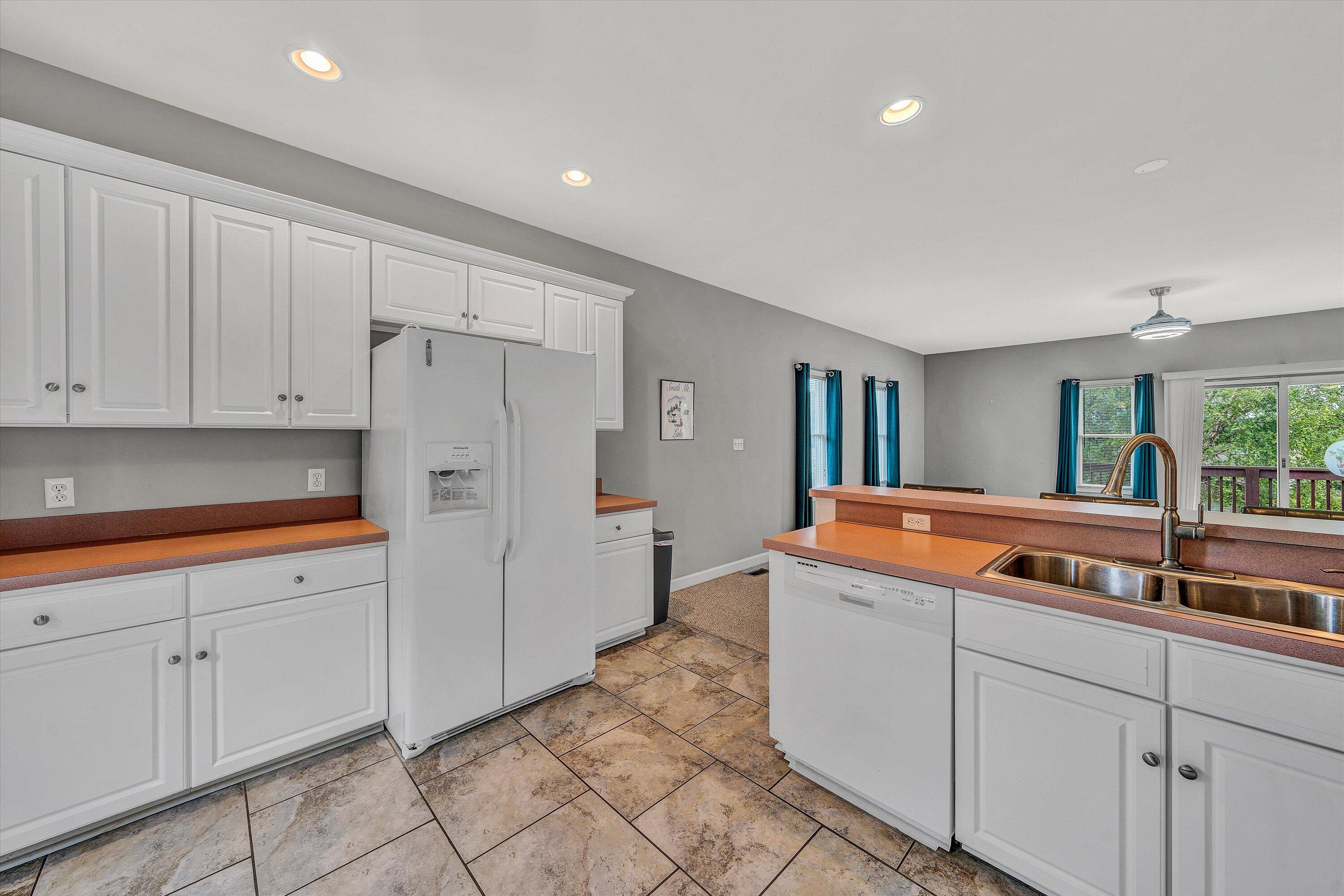 2326 Lake Retreat Road Huddleston, VA 24104 - Photo 6 of 42 a kitchen with stainless steel appliances granite countertop a refrigerator and a sink