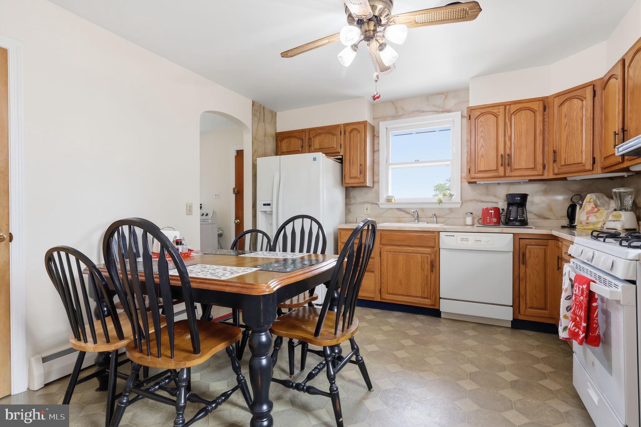 1413 Poplar Road Feasterville-Trevose, PA 19053 - Photo 9 of 35 a kitchen with a dining table chairs stainless steel appliances and cabinets