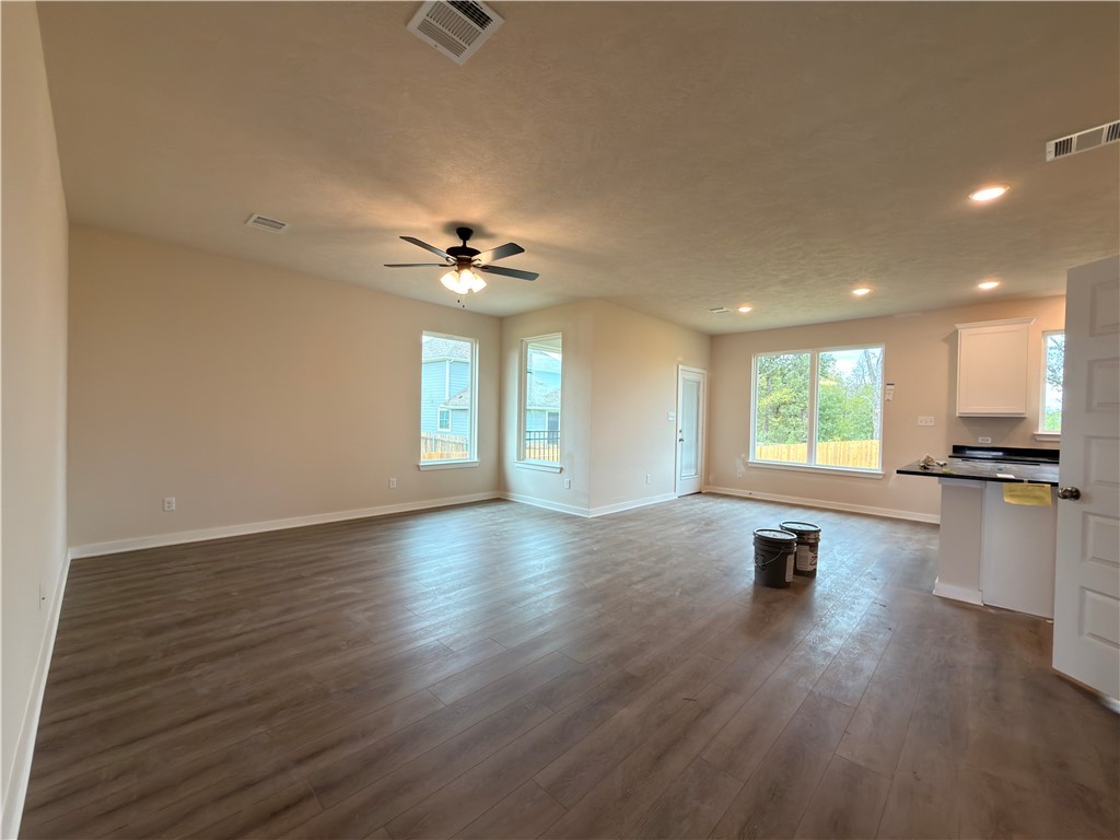 1394 Kingsgate Drive Bryan, TX 77807 - Photo 4 of 10 a view of empty room with wooden floor and window