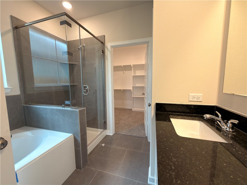 1394 Kingsgate Drive Bryan, TX 77807 - Photo 9 of 10 a bathroom with a tub and shower