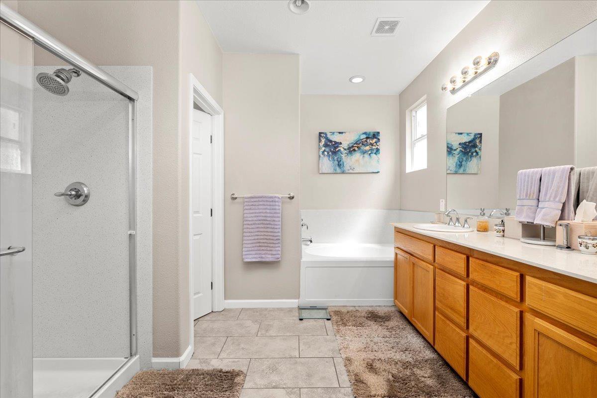 702 Annemarie Way Isleton, CA 95641 - Photo 12 of 18 a bathroom with a tub sink and mirror