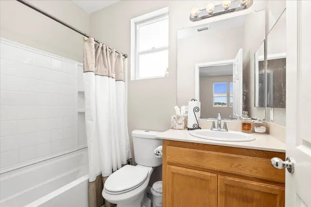 a bathroom with a granite countertop sink toilet a mirror and shower