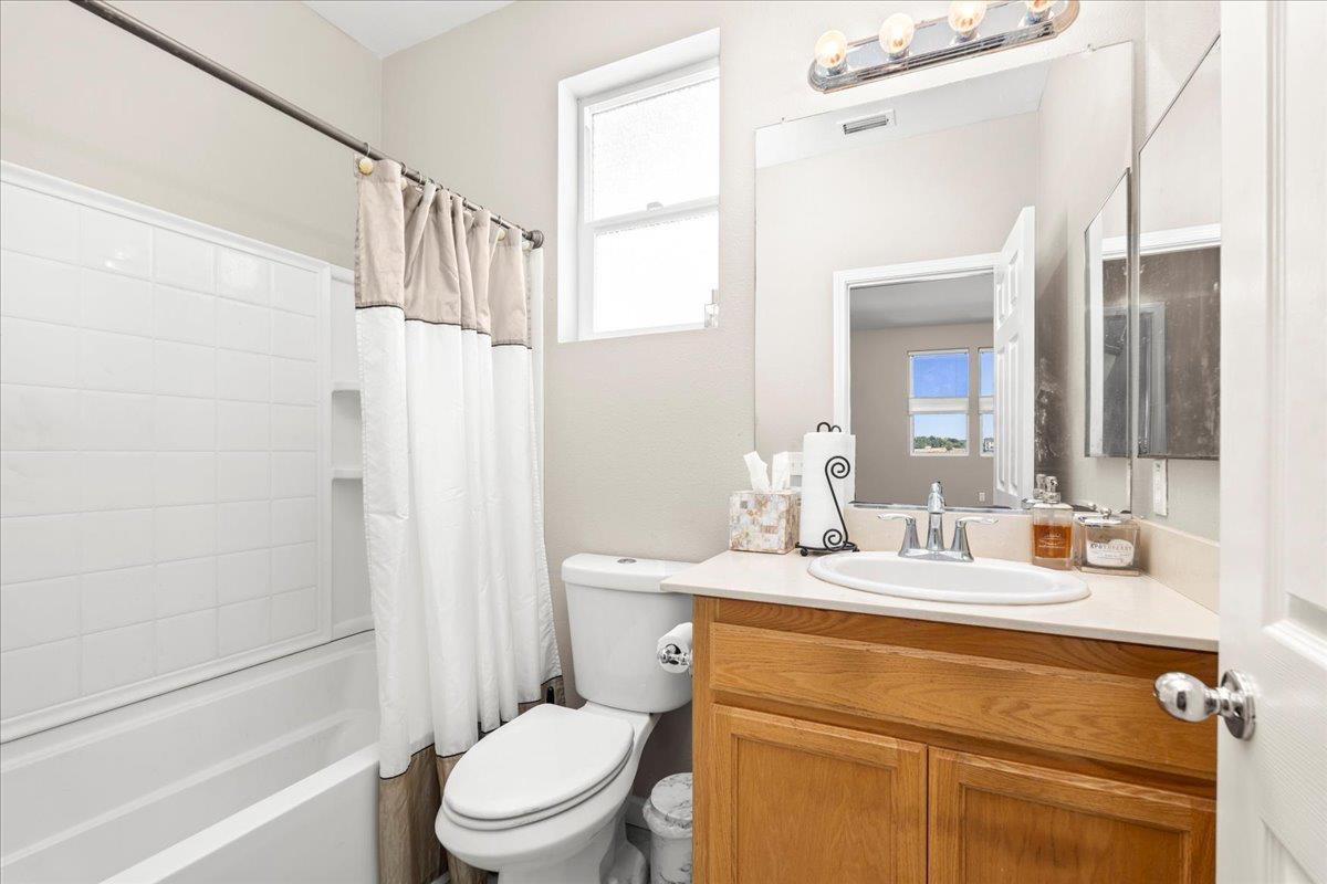 702 Annemarie Way Isleton, CA 95641 - Photo 17 of 18 a bathroom with a granite countertop sink toilet a mirror and shower