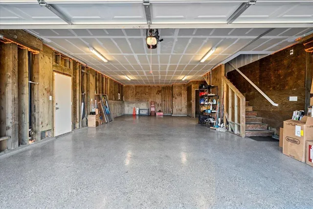 a view of a hallway with stairs and chandelier