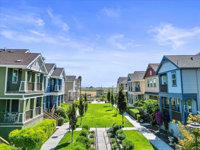a front view of a residential apartment building with a yard
