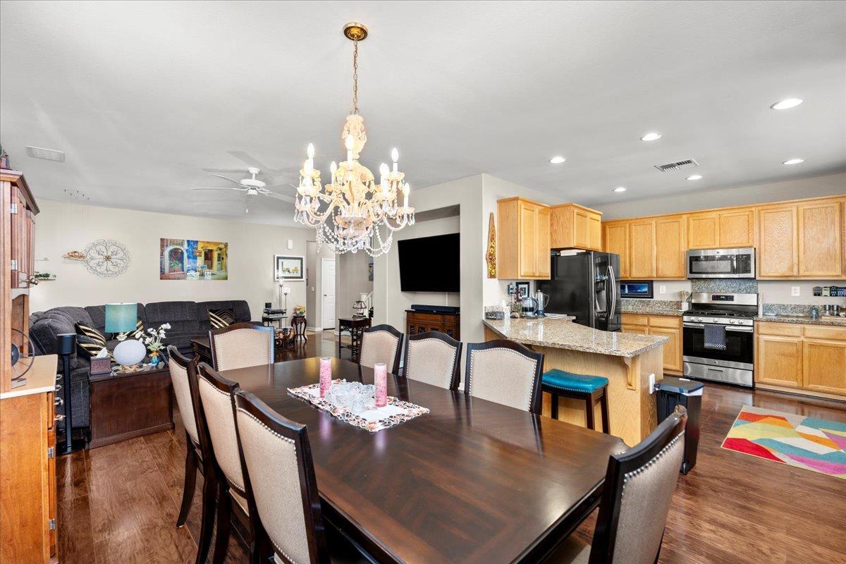 702 Annemarie Way Isleton, CA 95641 - Photo 7 of 18 a view of a dining room and livingroom with furniture wooden floor a chandelier