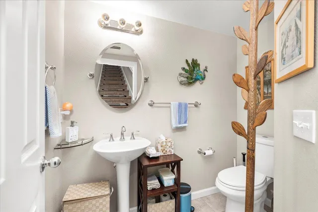 a bathroom with a sink mirror and toilet