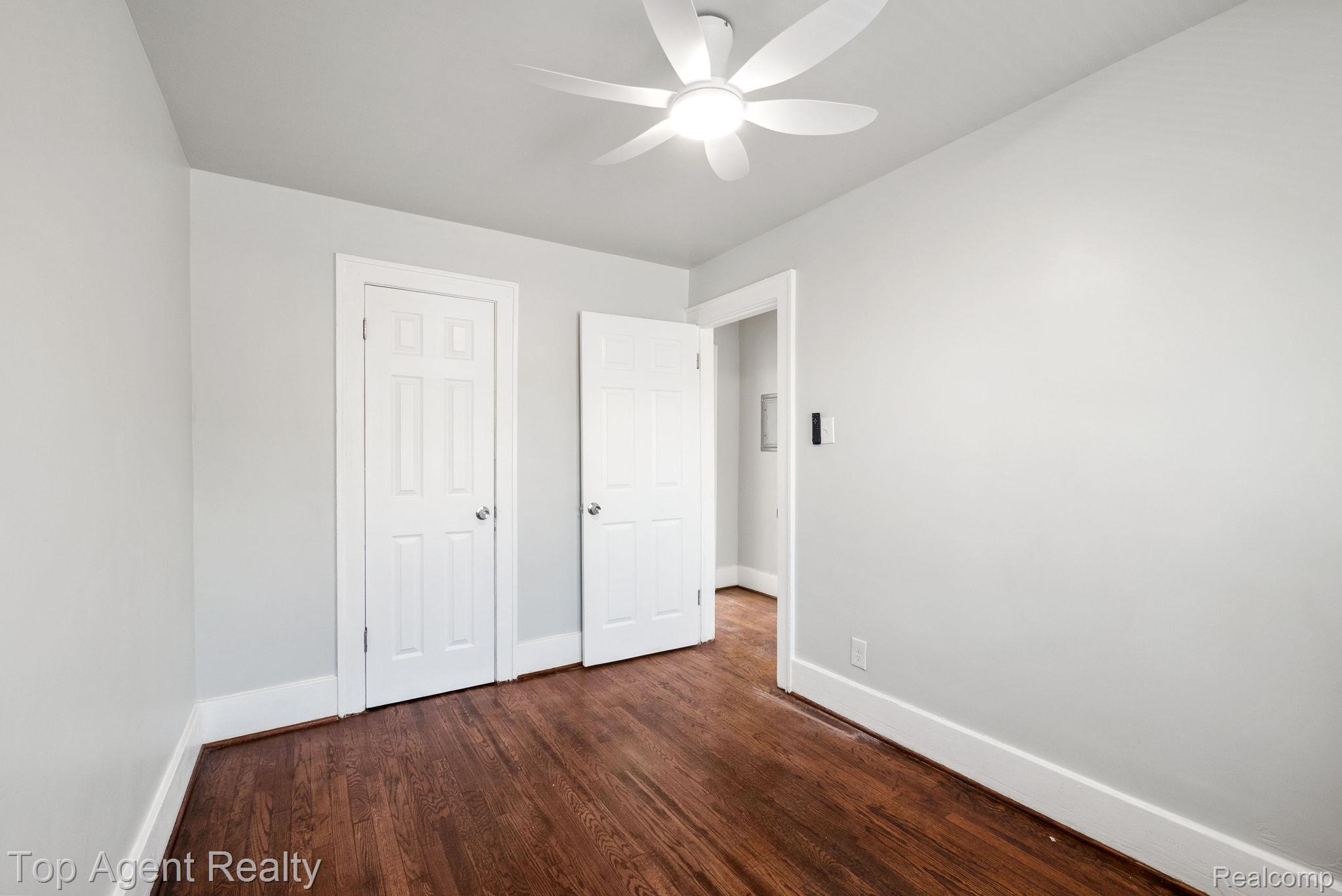 19217 Reno Street Detroit, MI 48205 - Photo 37 of 45 Hardwood flooring, painted walls, two paneled doors, ceiling-mounted light fixture with fan
