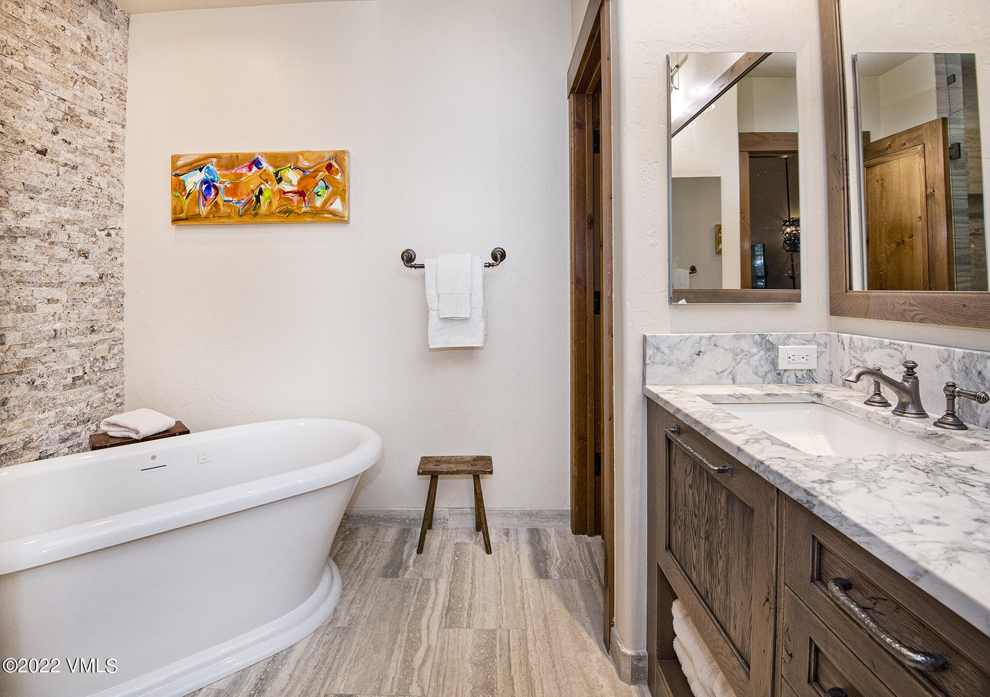 1250 Bachelor Ridge Road Avon, CO 81620 - Photo 19 of 60 a bathroom with a granite countertop sink a toilet and a mirror