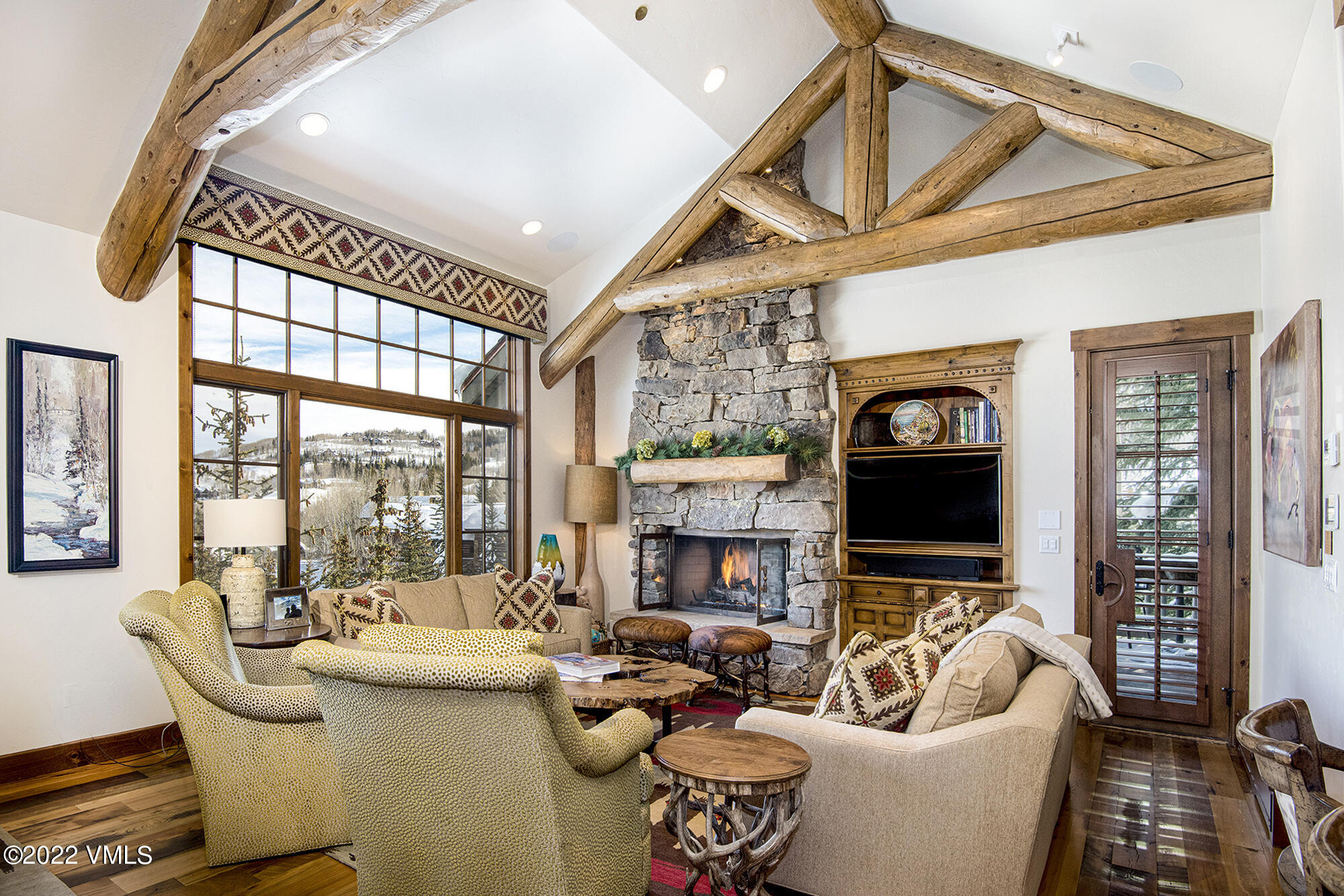 1250 Bachelor Ridge Road Avon, CO 81620 - Photo 2 of 60 a living room with fireplace furniture and a large window