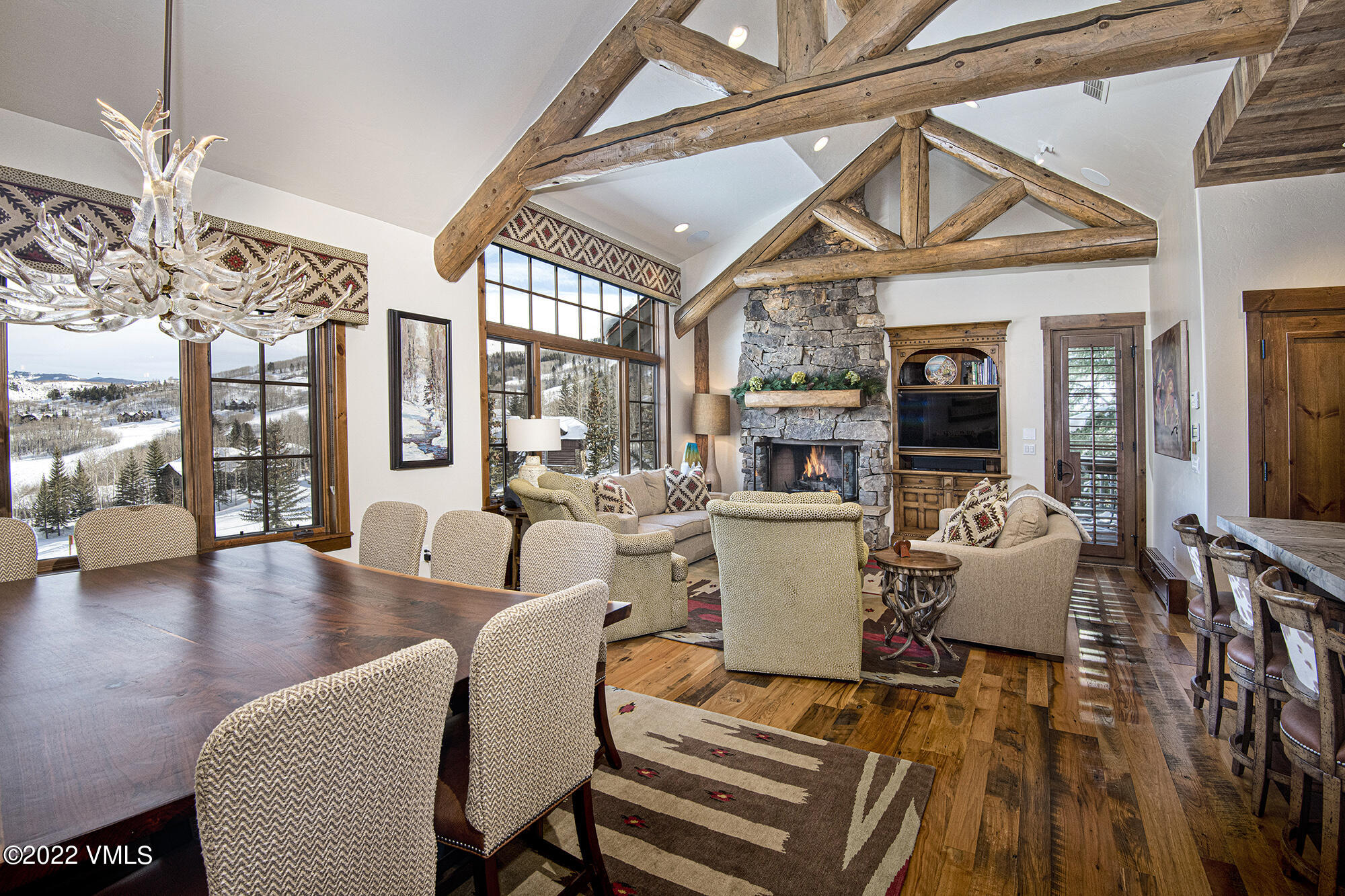 1250 Bachelor Ridge Road Avon, CO 81620 - Photo 3 of 60 a living room with furniture a flat screen tv and a floor to ceiling window