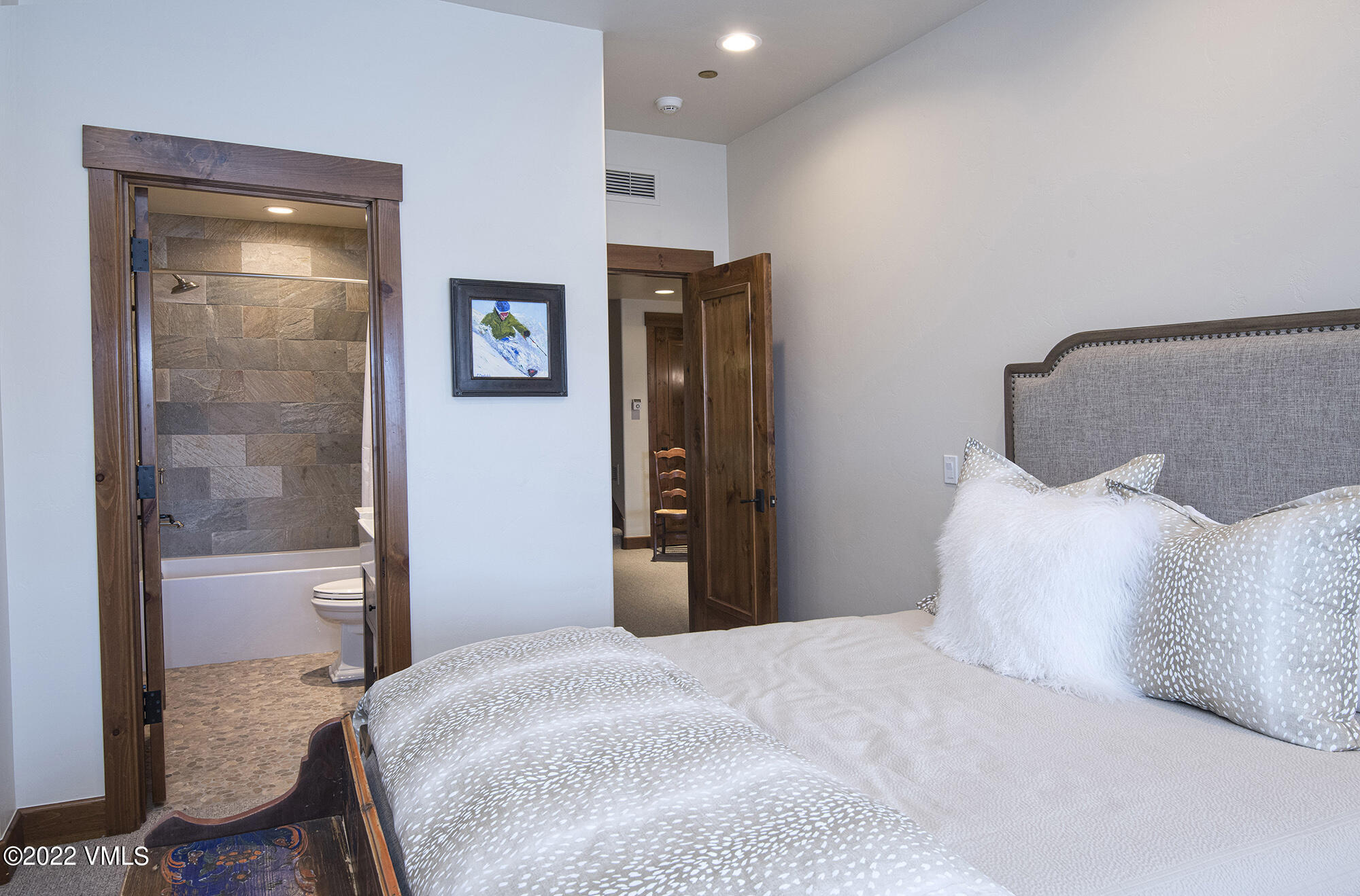 1250 Bachelor Ridge Road Avon, CO 81620 - Photo 31 of 60 a bedroom with a bed and a mirror