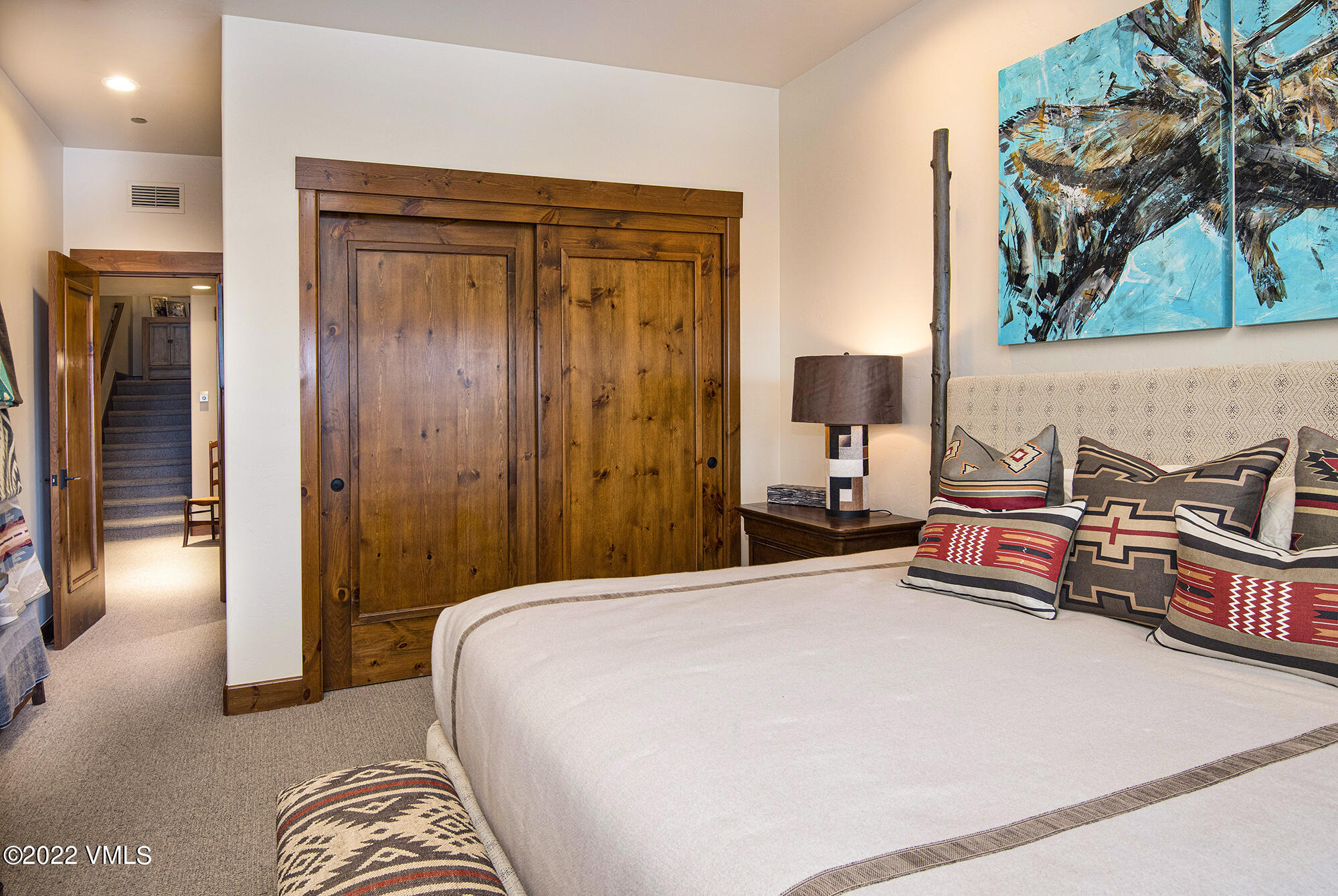 1250 Bachelor Ridge Road Avon, CO 81620 - Photo 35 of 60 a bedroom with a bed and a painting on the wall