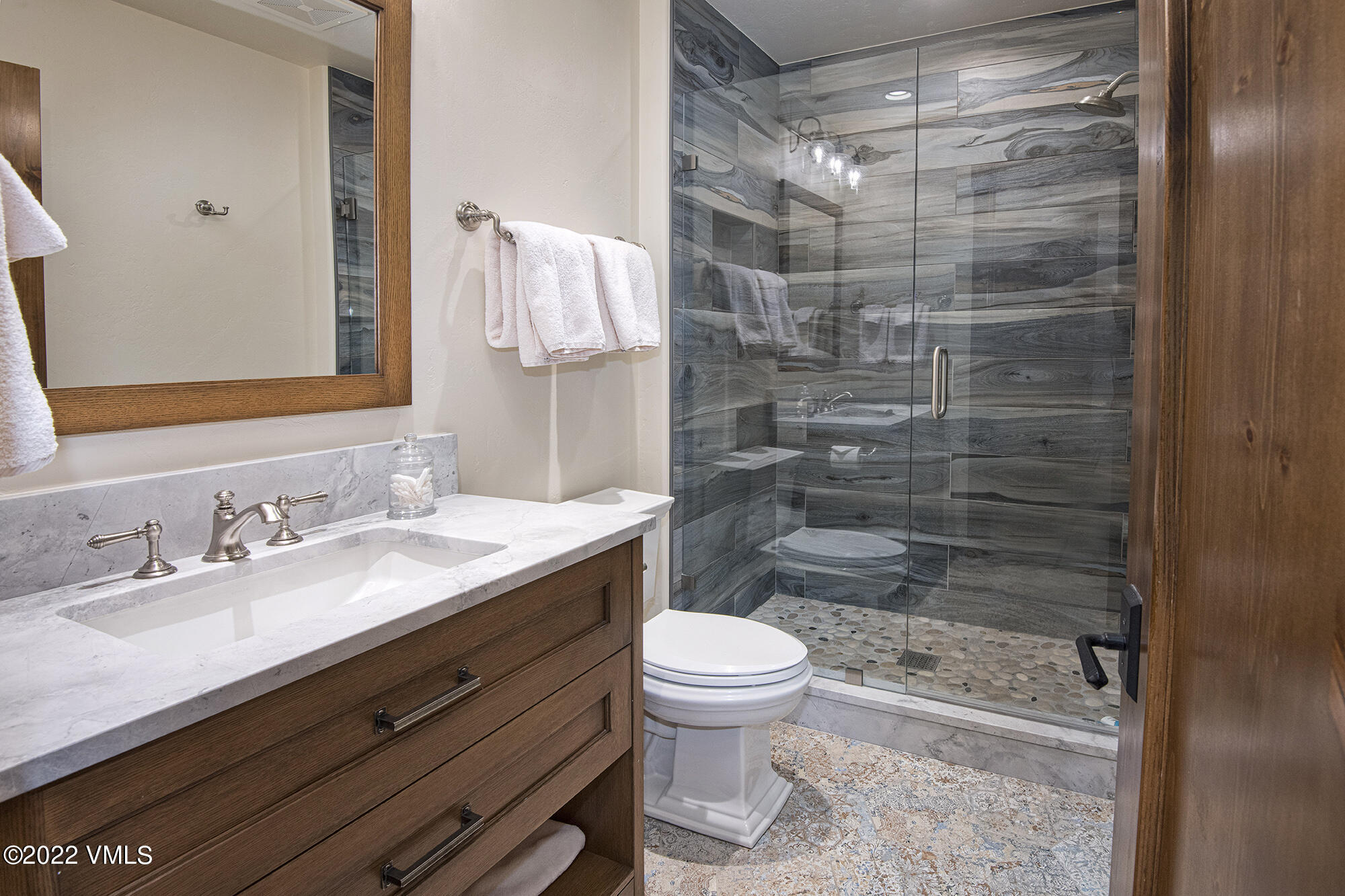 1250 Bachelor Ridge Road Avon, CO 81620 - Photo 36 of 60 a bathroom with a granite countertop sink toilet and shower