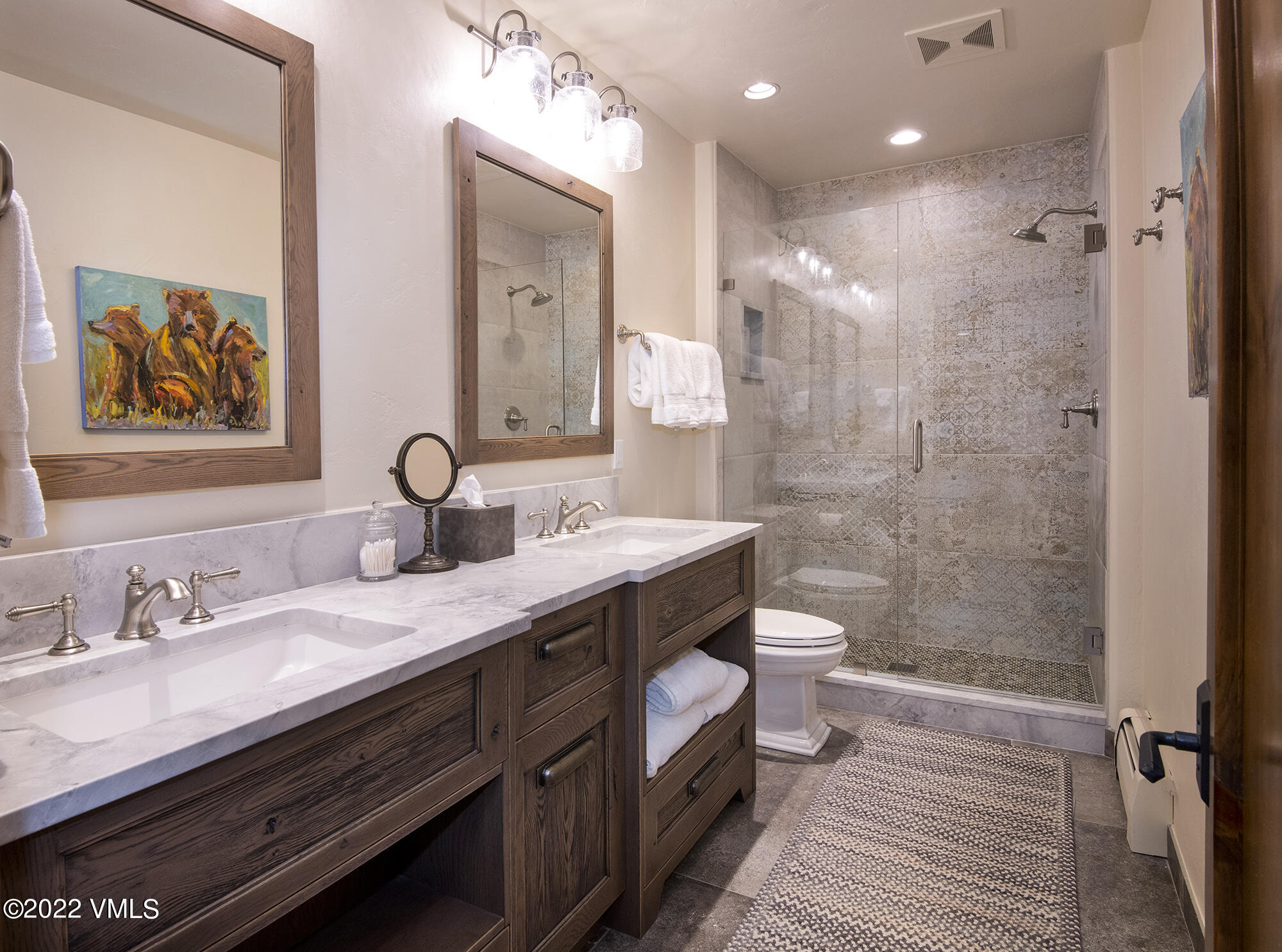 1250 Bachelor Ridge Road Avon, CO 81620 - Photo 38 of 60 a spacious bathroom with a granite countertop sink a toilet a shower and a mirror