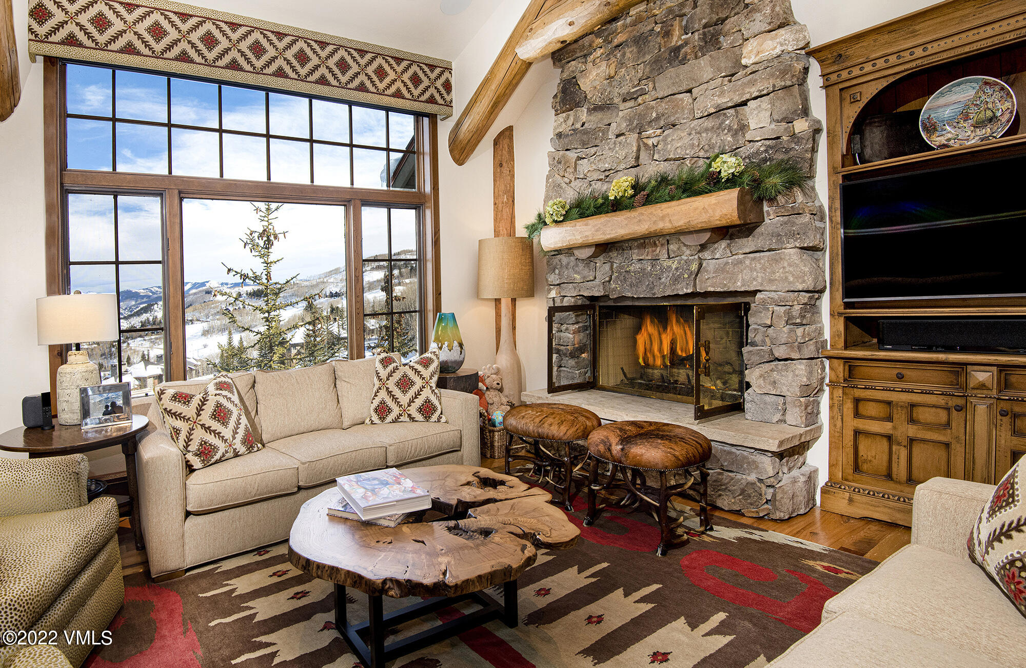 1250 Bachelor Ridge Road Avon, CO 81620 - Photo 5 of 60 a living room with furniture fireplace and a flat screen tv