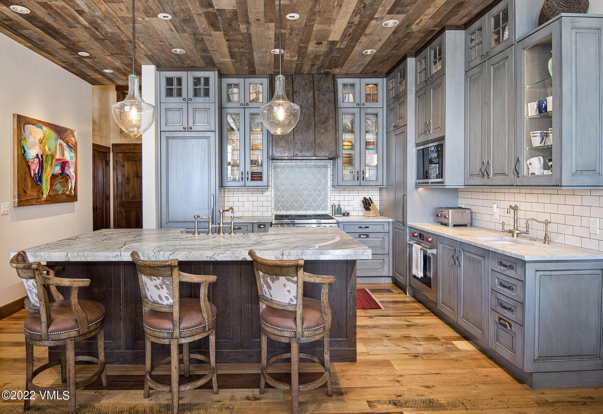 1250 Bachelor Ridge Road Avon, CO 81620 - Photo 9 of 60 a large kitchen with a table and chairs in it