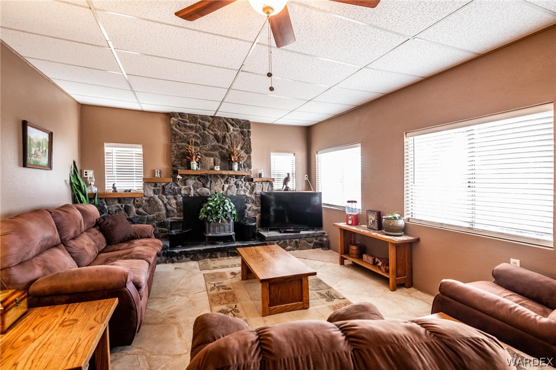 3341 Marana Road Golden Valley, AZ 86413 - Photo 12 of 46 a living room with furniture a flat screen tv and a large window