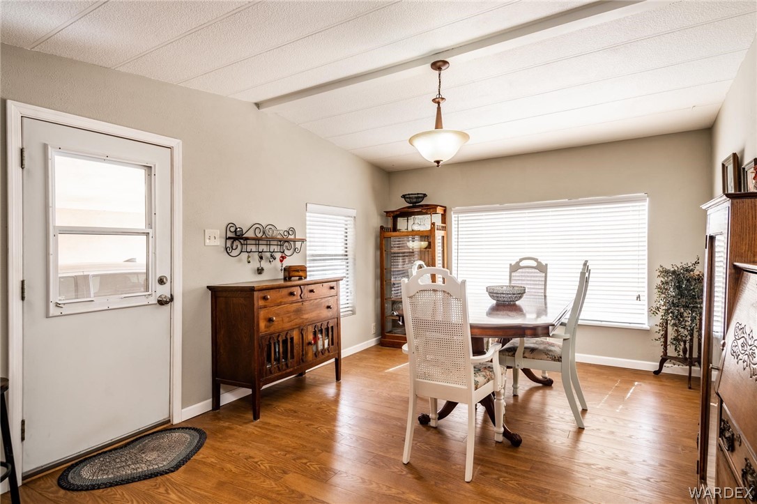 3341 Marana Road Golden Valley, AZ 86413 - Photo 19 of 46 a view of a dining room with furniture window and wooden floor