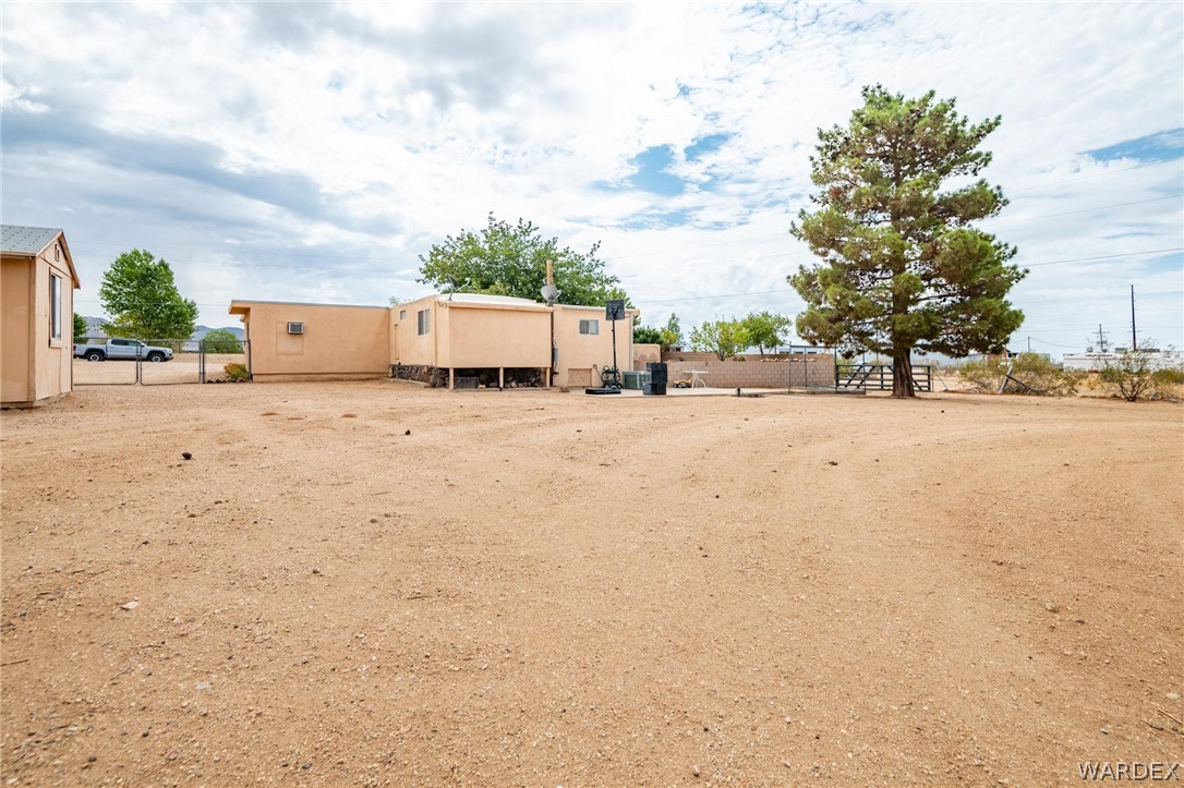 3341 Marana Road Golden Valley, AZ 86413 - Photo 44 of 46 a row of house with yard and car parked