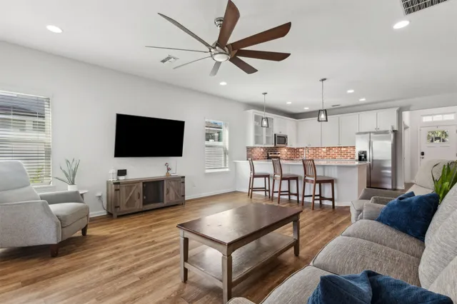 a living room with furniture and a wooden floor