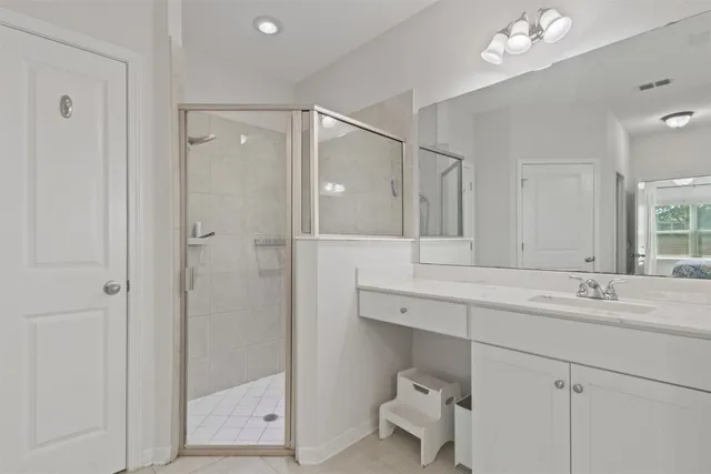 an empty room with wooden floor cabinet and windows