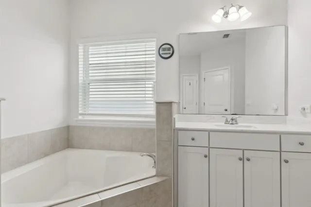 a bathroom with a granite countertop sink a toilet and shower