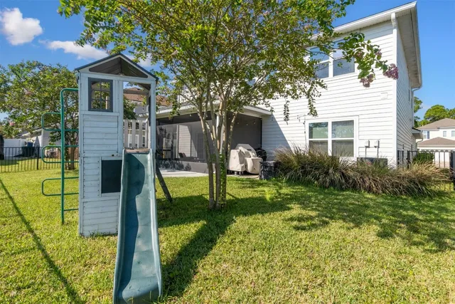 an aerial view of lake and residential houses with outdoor space