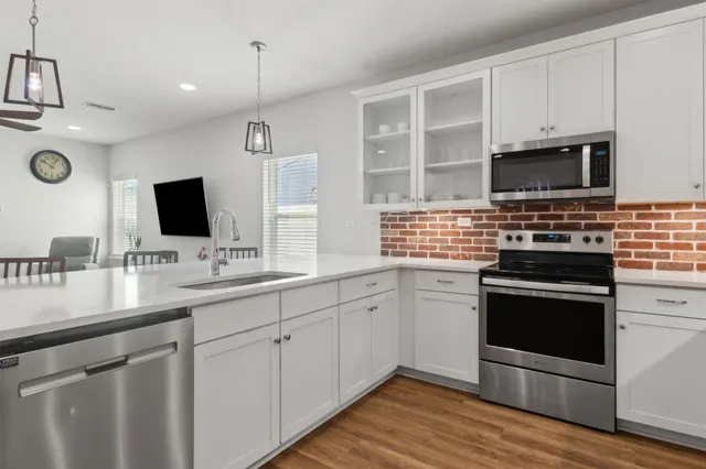a kitchen with stainless steel appliances a stove and a refrigerator