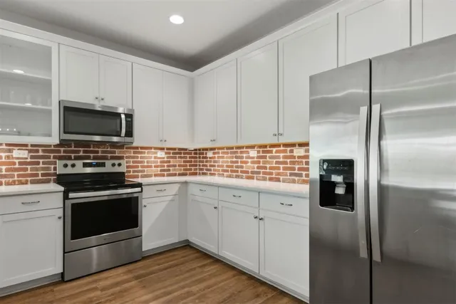 a kitchen with sink cabinets and wooden floor