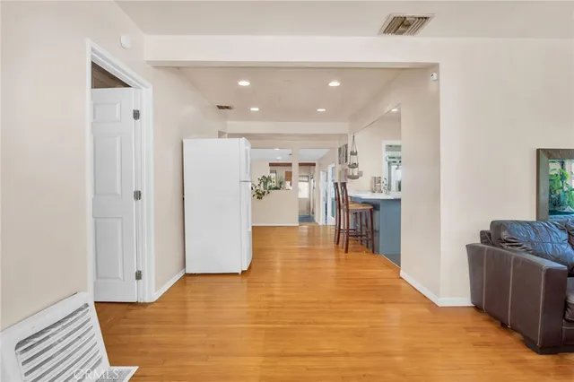 a view of a kitchen with furniture and wooden floor