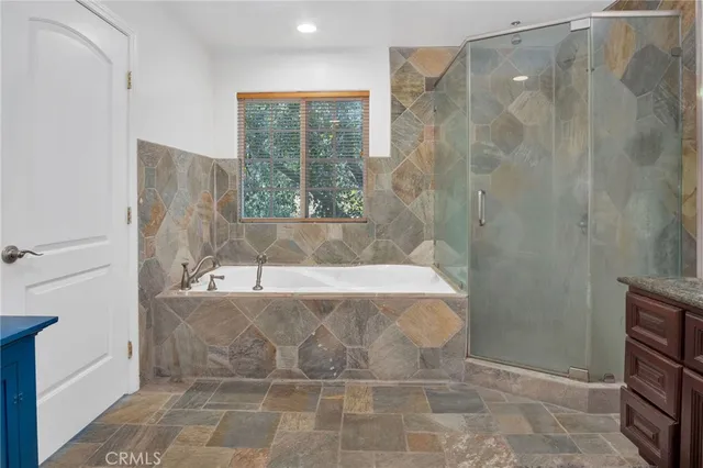 a bath tub sitting in a bathroom next to a window