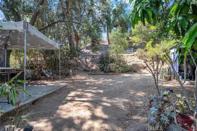 a view of a patio with table and chairs under an umbrella