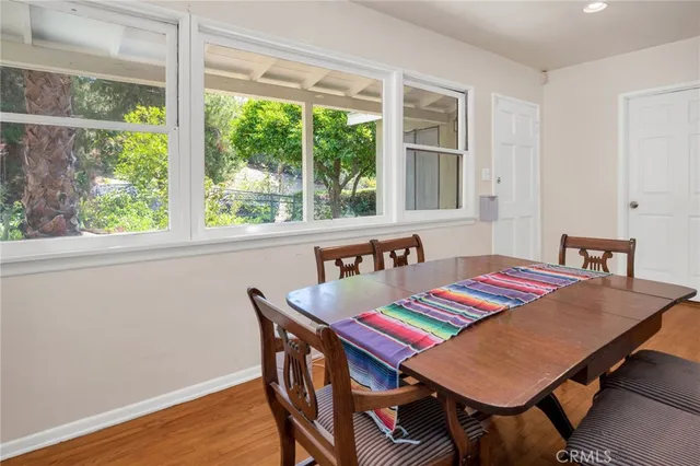 a dining room with furniture and wooden floor