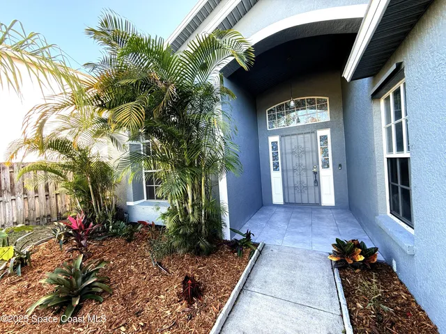a view of a room with wooden floor and ceiling fan