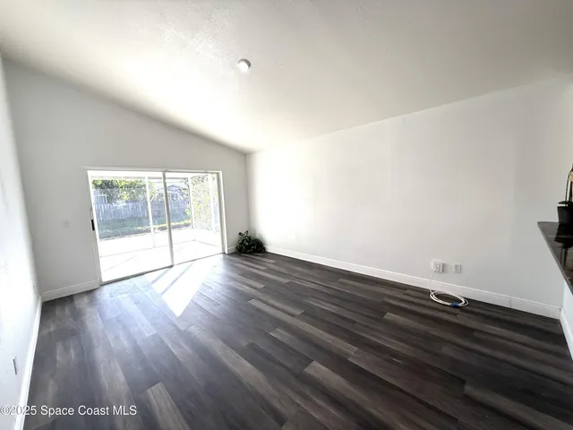 a kitchen with a stove a sink and a window