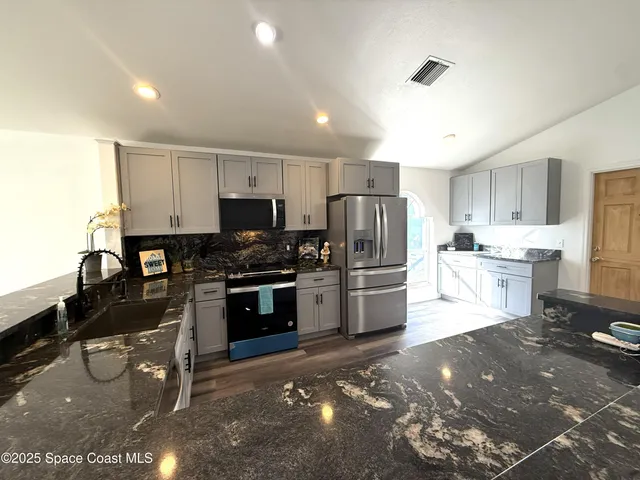 a view of empty room with window and wooden floor