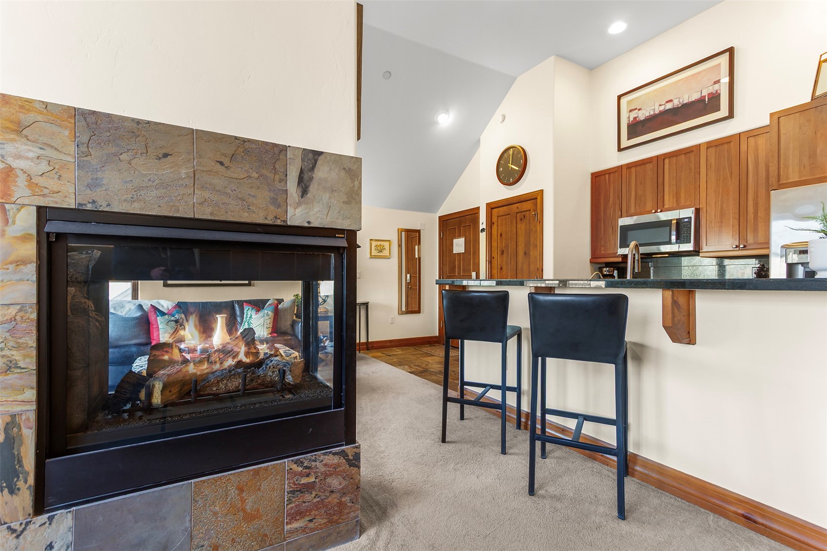 34 Highfield Trail, Unit 404 Breckenridge, CO 80424 - Photo 15 of 25 a living room with furniture a fireplace and a flat screen tv
