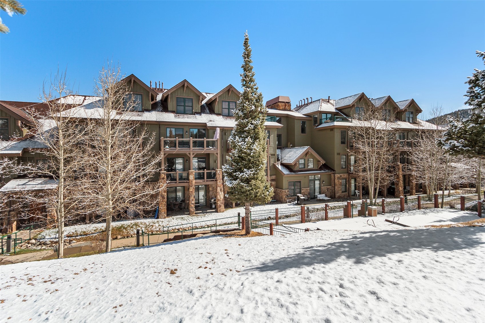 34 Highfield Trail, Unit 404 Breckenridge, CO 80424 - Photo 24 of 25 a view of a building with a snow on the road