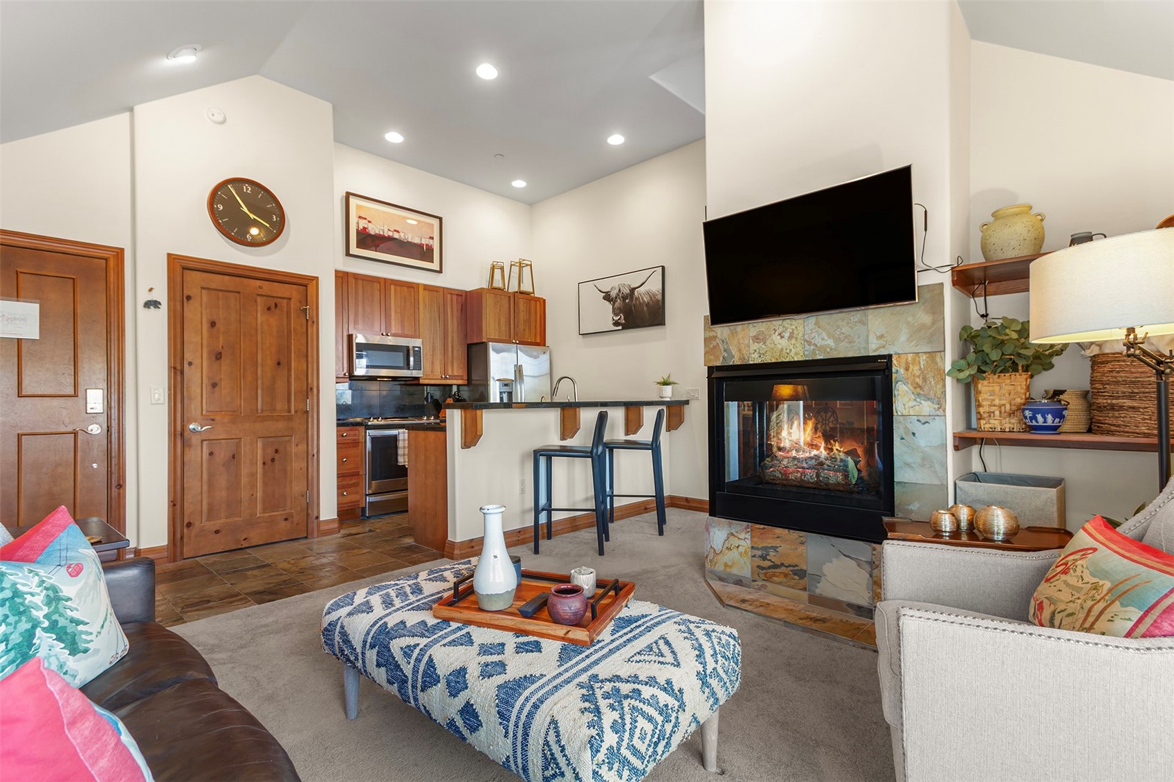 34 Highfield Trail, Unit 404 Breckenridge, CO 80424 - Photo 7 of 25 a living room with furniture flat screen tv and a fireplace