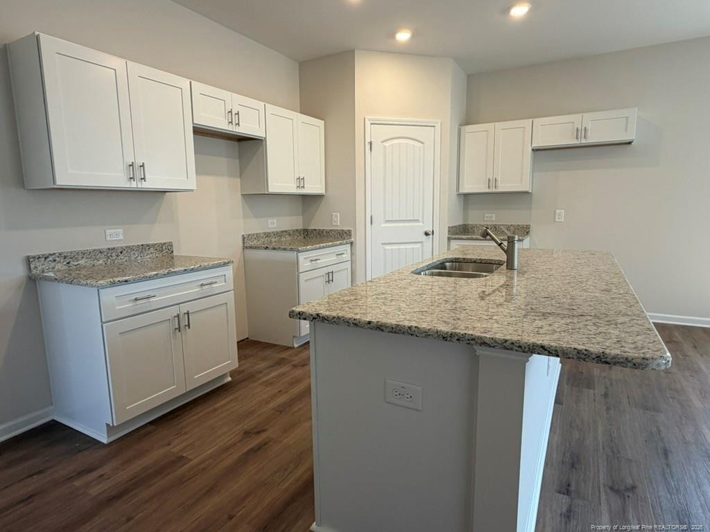5409 Short Leaf Road Fayetteville, NC 28311 - Photo 13 of 40 a kitchen with granite countertop white cabinets and a sink