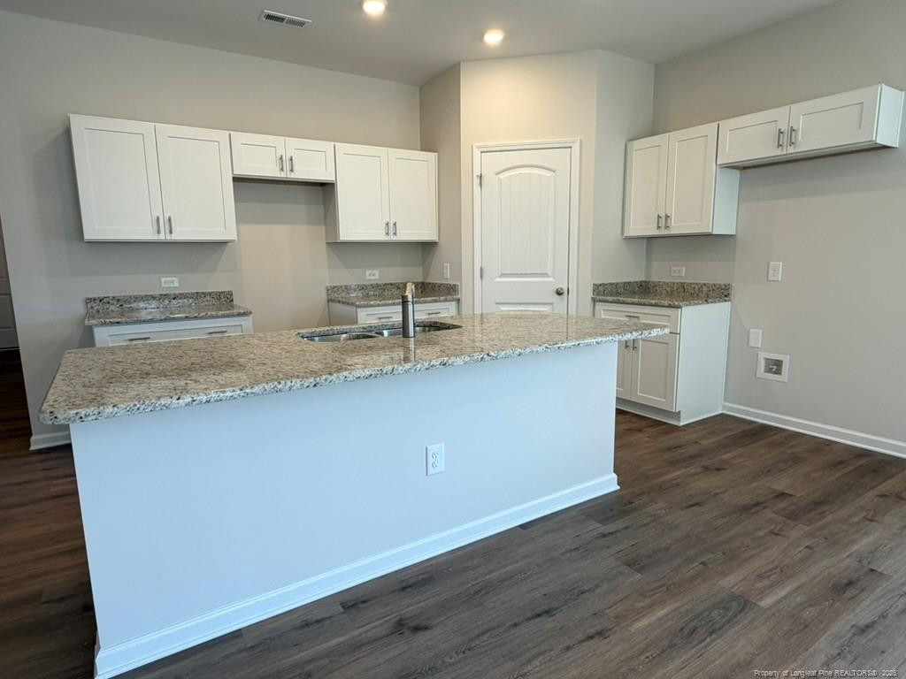5409 Short Leaf Road Fayetteville, NC 28311 - Photo 15 of 40 a kitchen with stainless steel appliances granite countertop a sink a stove a refrigerator and white cabinets