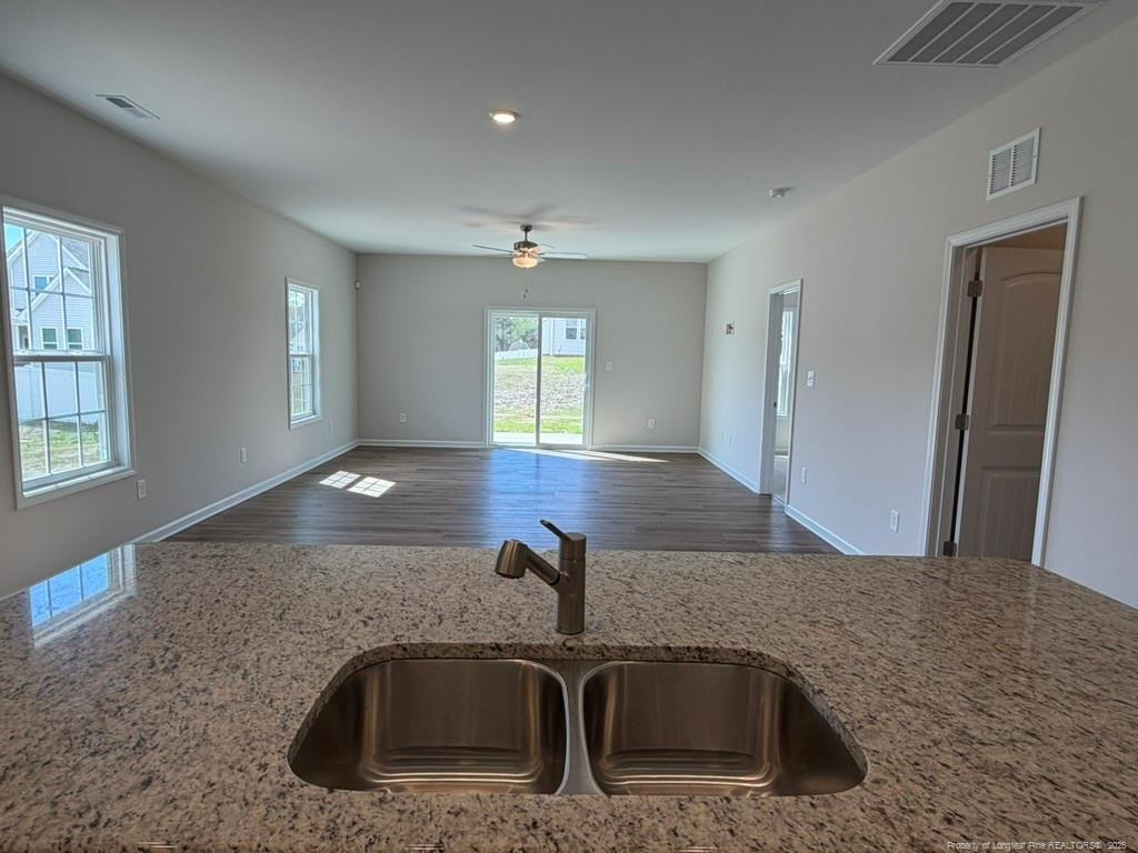5409 Short Leaf Road Fayetteville, NC 28311 - Photo 17 of 40 a kitchen with granite countertop a sink and a mirror