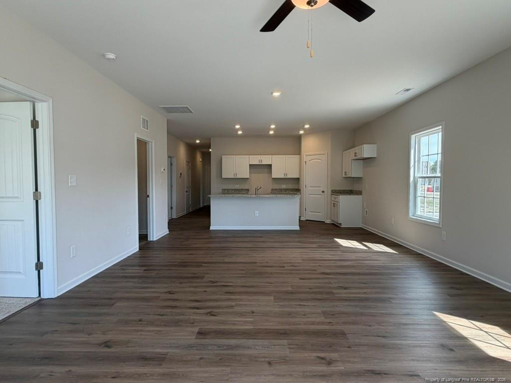 5409 Short Leaf Road Fayetteville, NC 28311 - Photo 21 of 40 a view of kitchen and empty room with wooden floor