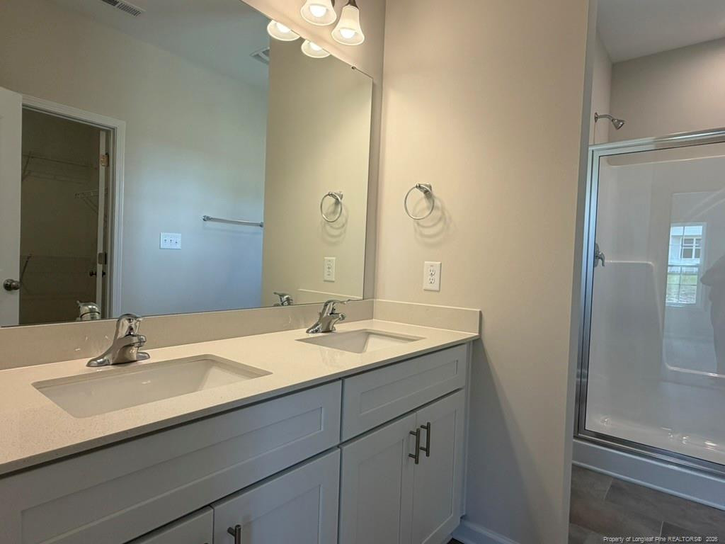 5409 Short Leaf Road Fayetteville, NC 28311 - Photo 26 of 40 a bathroom with a sink double vanity and a mirror