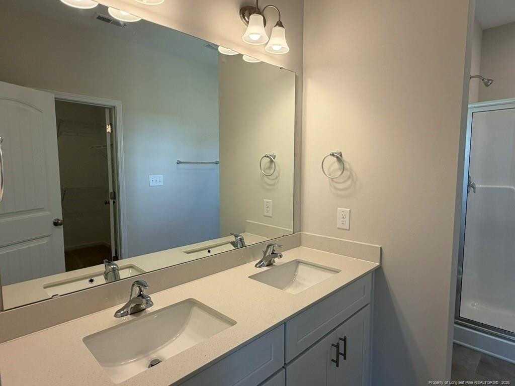 5409 Short Leaf Road Fayetteville, NC 28311 - Photo 27 of 40 a bathroom with a sink and a mirror