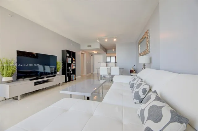 a view of a livingroom with furniture and a flat screen tv