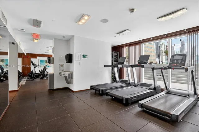 a room with gym equipment and large window