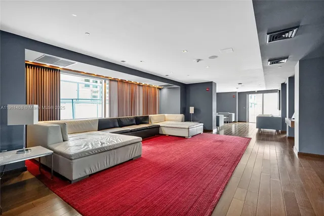 a spacious bedroom with a bed window and couch